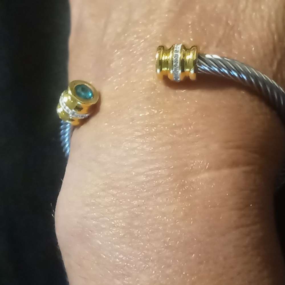 Twisted cable cuff bracelet with crystal cut blue ends silver and gold tone